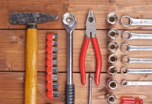 Set of different work tools on wooden brown surface